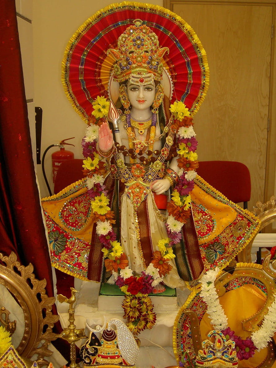 Lord Murugan Murti Adorned With Flower Garlands And Traditional Temple Attire HD phone wallpaper