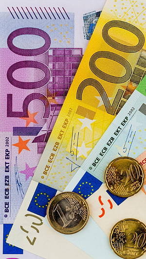 Close-up of Euro banknotes and coins featuring 500, 200, and 50 denominations with ECB markings HD phone wallpaper