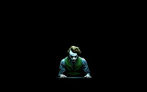 The Joker Leaning Forward in Dark Cinematic Lighting HD wallpaper