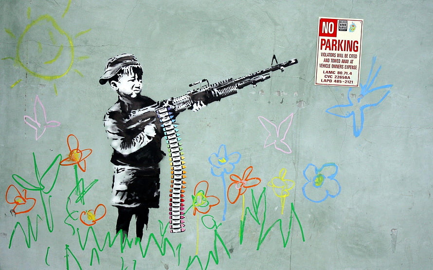 Banksy Street Art of a Boy Soldier Holding a Machine Gun Amidst Colorful Flowers and Butterflies HD wallpaper