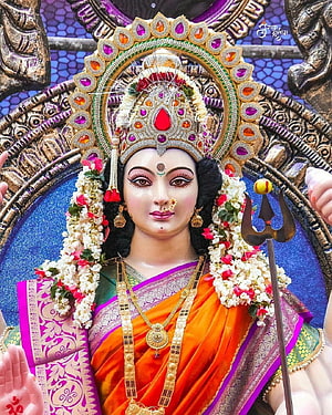 Ornate Durga Mata Murti Adorned in Vibrant Saree with Trishul and Floral Garland HD phone wallpaper