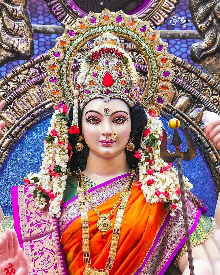 Ornate Durga Mata Murti Adorned in Vibrant Saree with Trishul and Floral Garland HD phone wallpaper