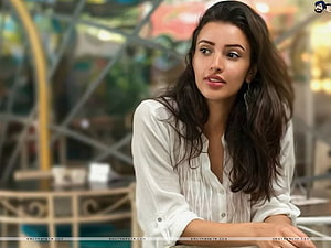 Tripti Dimri in a White Blouse with Long Dark Hair in a Softly Lit Indoor Setting HD wallpaper