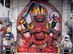 Kaal Bhairav Temple Deity Sculpture with Lion Guardians and Traditional Offerings HD wallpaper