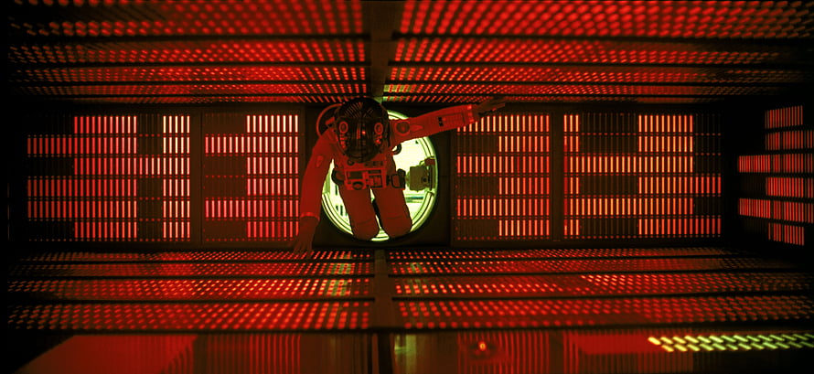2001: A Space Odyssey astronaut floating in red-lit spacecraft corridor HD wallpaper