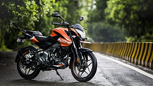 Orange Bajaj Pulsar NS125 Motorcycle Parked on a Scenic Forest Road HD wallpaper