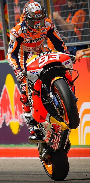 Marc Marquez performing a wheelie on his Repsol Honda RC213V motorcycle during a MotoGP race HD phone wallpaper