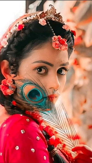 Mallika Singh as Radha in Traditional Attire with Peacock Feather and Floral Hairpiece HD phone wallpaper