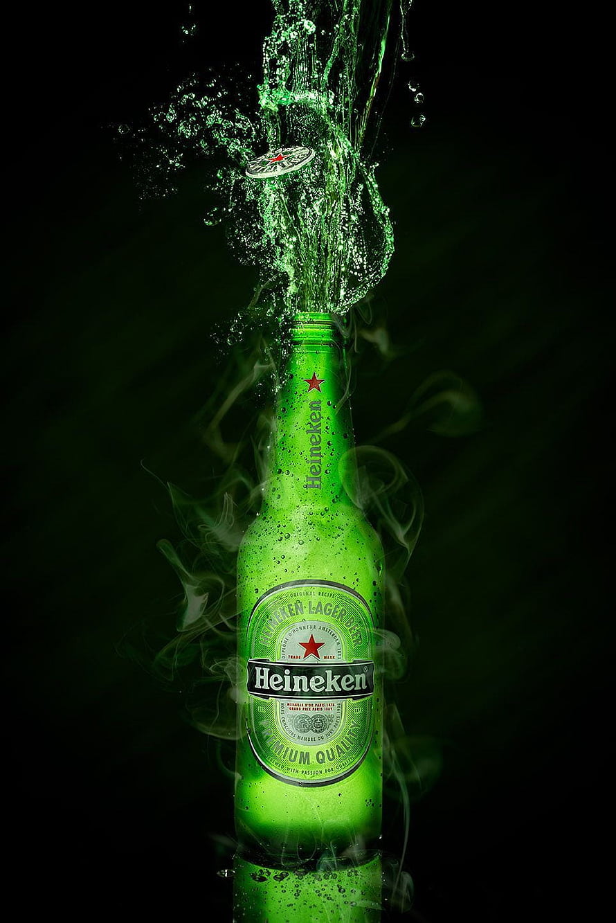 Heineken Lager Beer Bottle With Dramatic Green Splash And Rising Smoke Against A Dark Background HD phone wallpaper