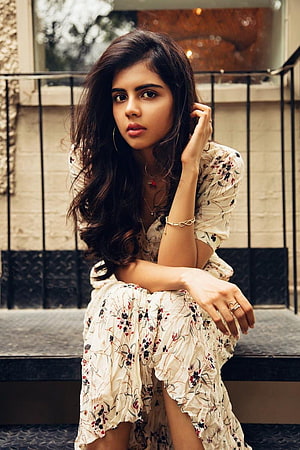 Kalyani Priyadarshan in a Floral Dress Sitting on Urban Steps HD phone wallpaper