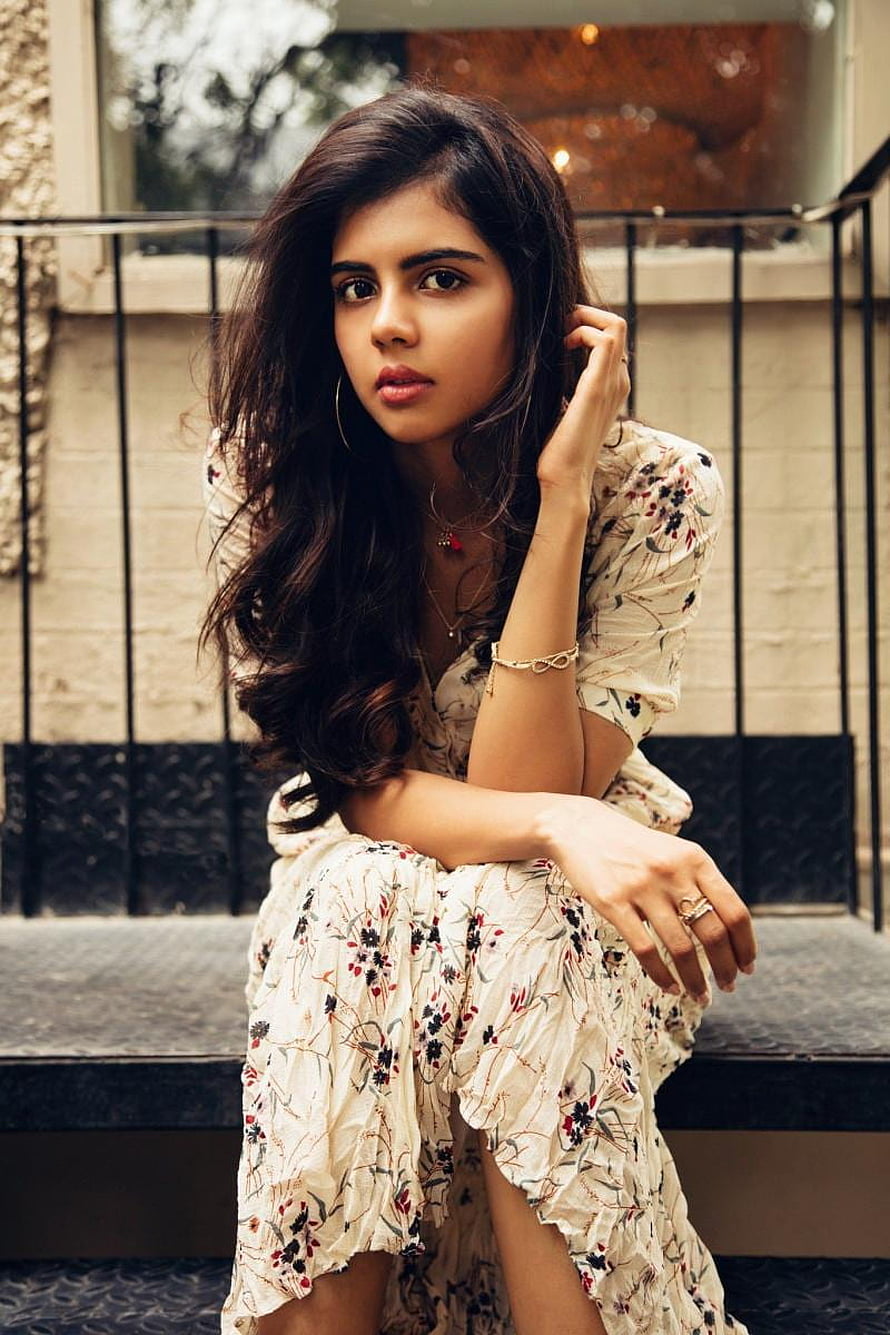 Kalyani Priyadarshan in a Floral Dress Sitting on Urban Steps HD phone wallpaper