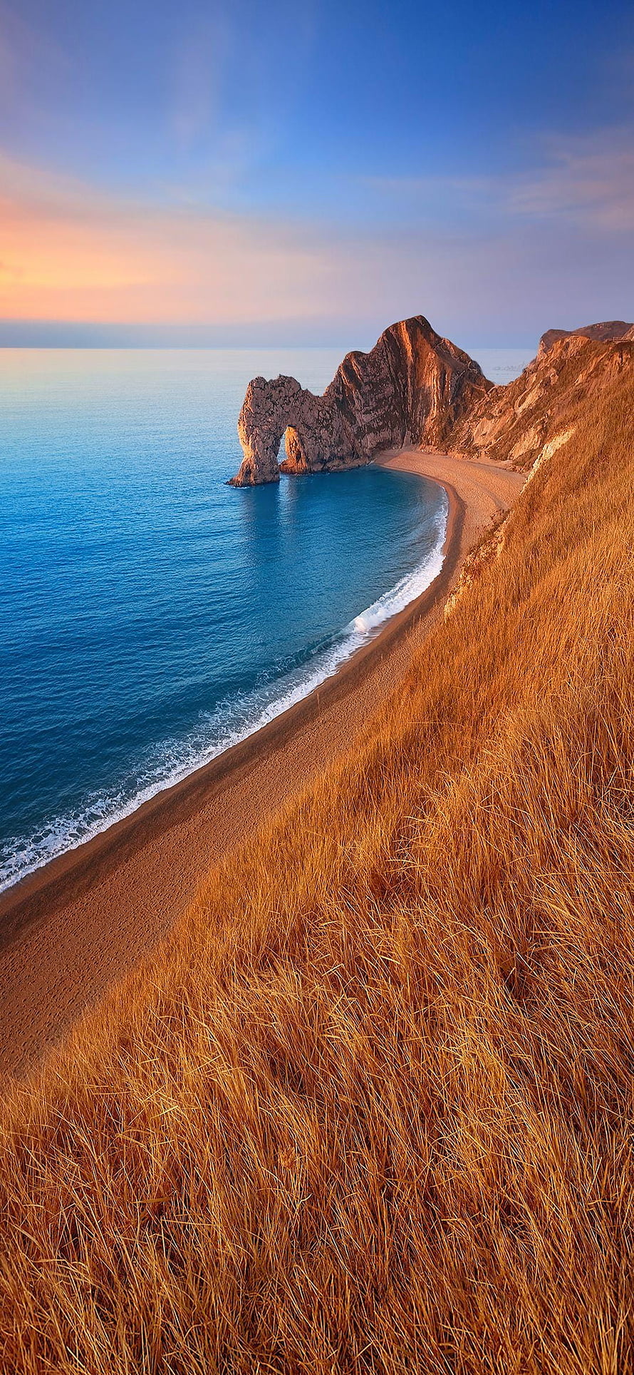 Golden Hour Coastal Cliffs and Sandy Beach with Turquoise Ocean Water HD phone wallpaper