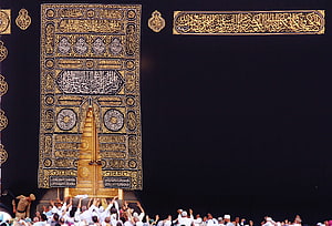 Golden Kaaba Door and Kiswa in Mecca with Pilgrims Reaching Toward the Sacred House HD wallpaper