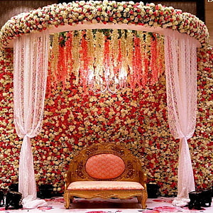 Luxurious Floral Wedding Stage with Ornate Gold Settee and Chandelier HD phone wallpaper
