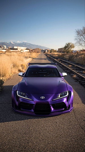 Purple Toyota Supra MK5 Front View on Railroad Tracks with Mountain Backdrop HD phone wallpaper