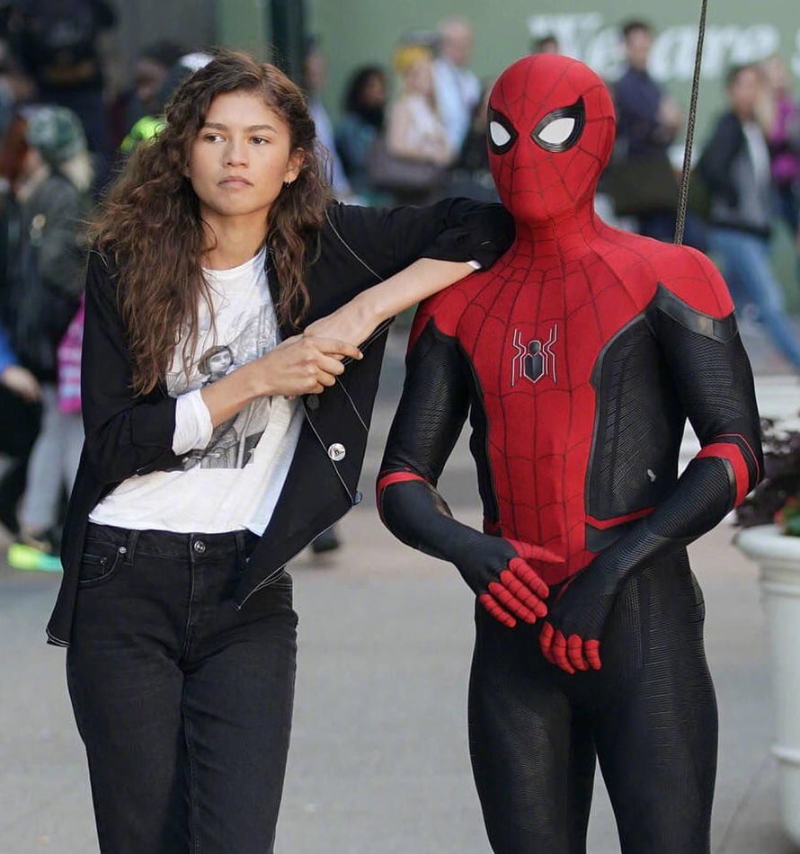 Zendaya and Spider-Man in the new red and black suit on a city street HD phone wallpaper