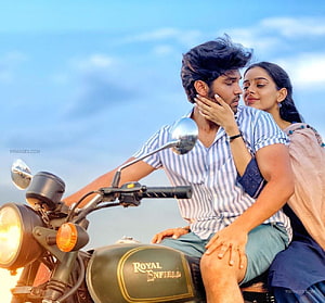 Adithya Varma and Actress on Royal Enfield Motorcycle in Romantic Tamil Movie Scene HD wallpaper