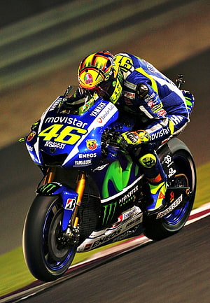 Valentino Rossi riding Yamaha Movistar MotoGP bike number 46 on the racetrack HD phone wallpaper