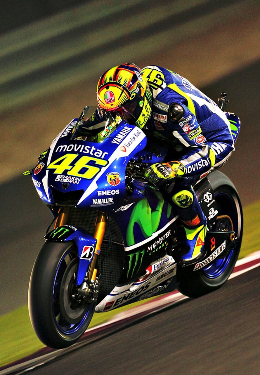 Valentino Rossi riding Yamaha Movistar MotoGP bike number 46 on the racetrack HD phone wallpaper