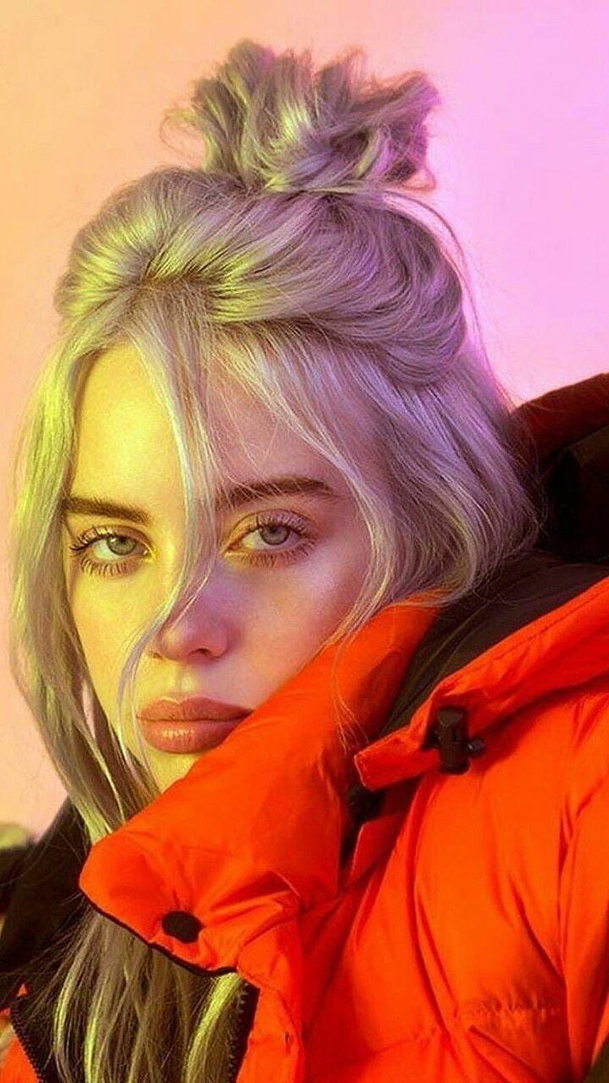 Billie Eilish Portrait in Vibrant Orange Puffer Jacket with Neon Lighting HD phone wallpaper
