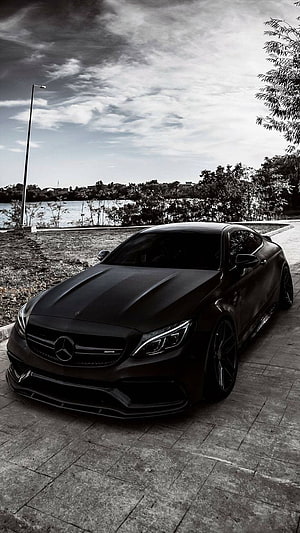 Black Mercedes-AMG C63 Coupe Parked on Lakeside Pavement in Dramatic Monochrome HD phone wallpaper