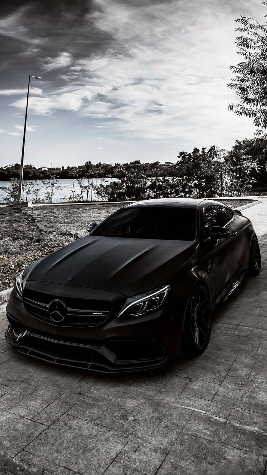 Black Mercedes-AMG C63 Coupe Parked on Lakeside Pavement in Dramatic Monochrome HD phone wallpaper