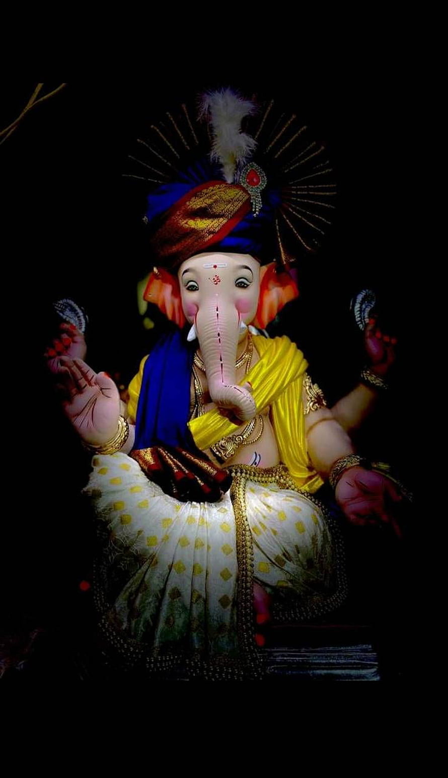 Ornate Ganesha Idol in Traditional Attire with Turban and Jewels on Black Background HD phone wallpaper