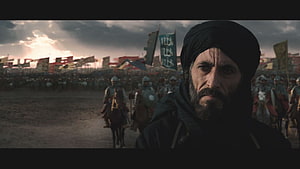 Saladin in Kingdom of Heaven with army banners and cavalry under a stormy sky HD wallpaper
