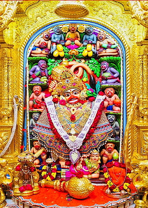 Salasar Balaji Temple Deity Surrounded by Colorful Monkey Figures and Golden Ornamentation HD phone wallpaper