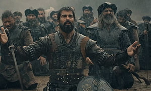 Kurulus Osman warrior in rain with sword and shield surrounded by soldiers HD wallpaper