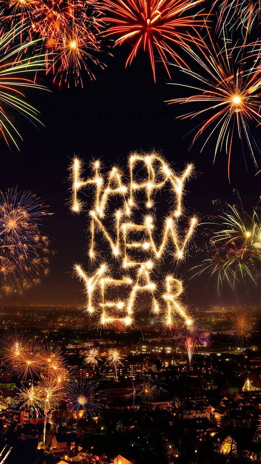 Fireworks Spelling Happy New Year Over a Glowing City Skyline at Night HD phone wallpaper