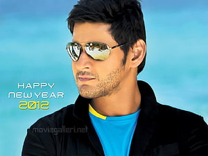 Mahesh Babu in aviator sunglasses and black jacket against a blue sky HD wallpaper