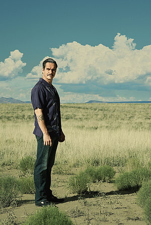 Lalo Salamanca Standing in a Vast Desert Landscape Under a Cloudy Sky HD phone wallpaper
