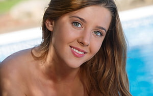 Smiling Woman With Long Brown Hair By A Blue Swimming Pool HD wallpaper