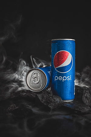 Chilled Pepsi Cans on Dark Rocks with Rising Smoke and Condensation HD phone wallpaper