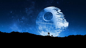 Star Wars Death Star looming over a dark landscape with two silhouetted figures under a starry night sky HD wallpaper
