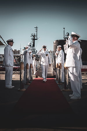 Navy Officers in White Dress Uniforms Saluting on a Red Carpet Aboard a Warship HD phone wallpaper