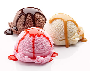 Three scoops of chocolate, vanilla, and strawberry ice cream with syrup drizzles on a white background HD wallpaper