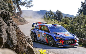 Hyundai i20 WRC Rally Car Cornering on Mountain Road HD wallpaper