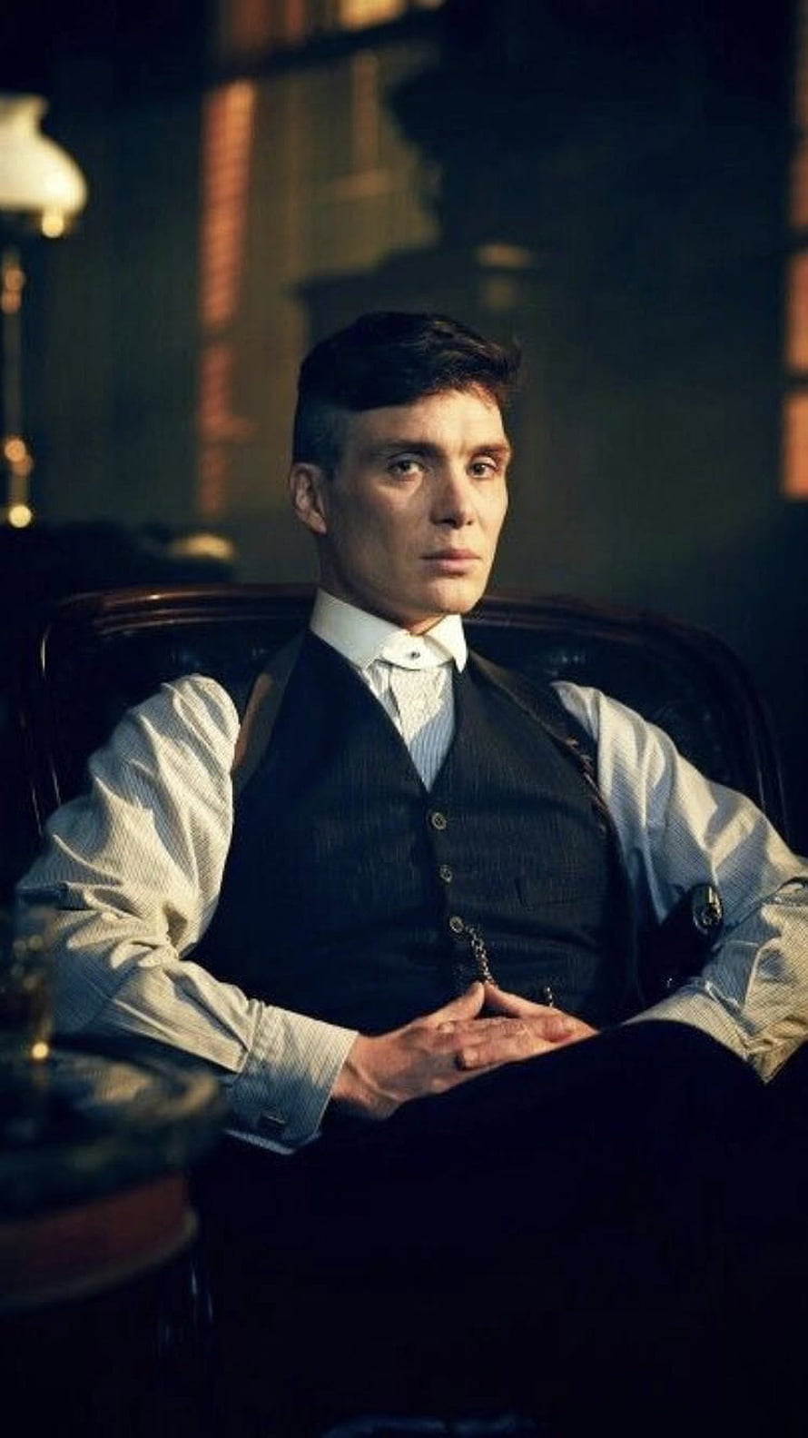Tommy Shelby in Period Formal Wear Seated in a Dimly Lit Victorian Study HD phone wallpaper
