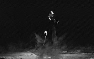 Mustafa Kemal Ataturk in a dramatic black and white portrait with cane and dust HD wallpaper