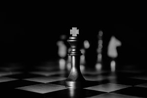 Dramatic Black and White Chess King Piece on a Dark Board HD wallpaper