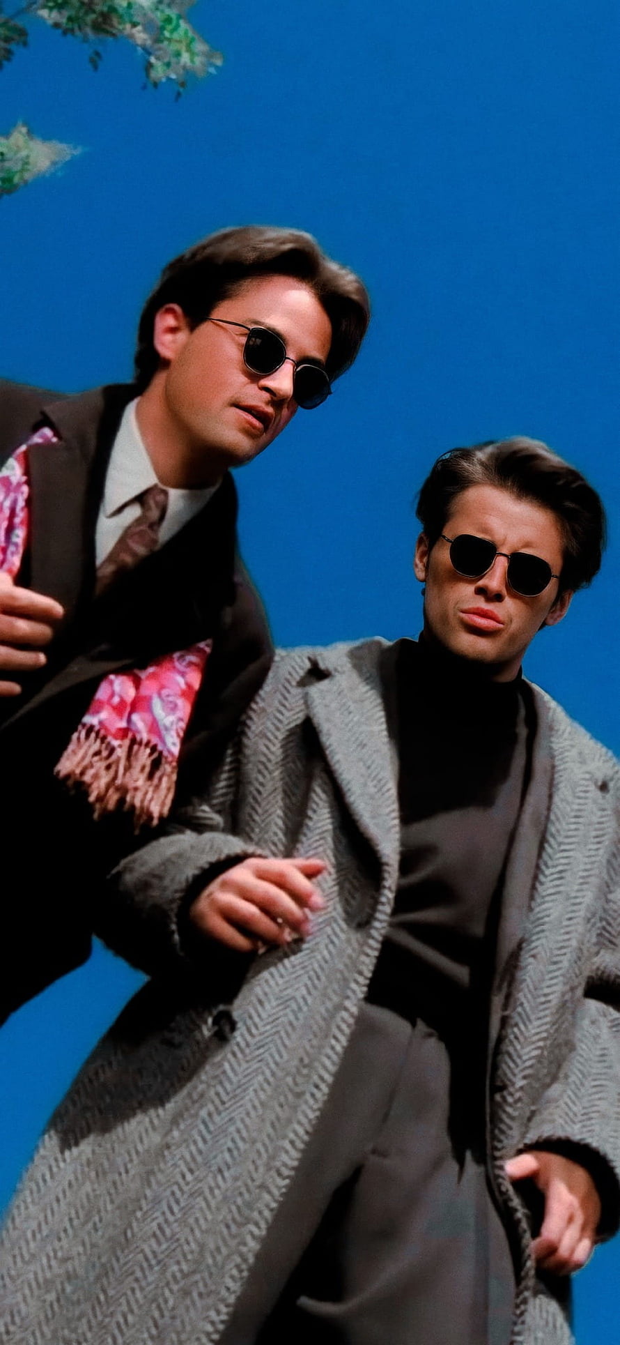 Joey and Chandler from Friends in stylish coats and sunglasses against a blue sky HD phone wallpaper