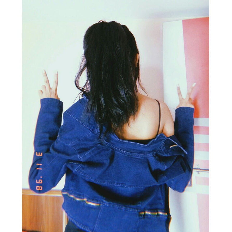 Aesthetic Back View Portrait of Woman in Denim Jacket Making Peace Sign HD phone wallpaper