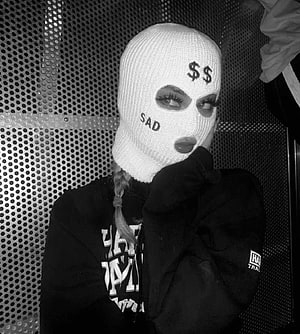 Black and white portrait of a woman wearing a white ski mask with embroidered text and dollar signs HD phone wallpaper