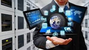 Businessman Holding Holographic Global Data Dashboard in Server Room HD wallpaper