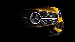 Mercedes-AMG GT Front Grille Close-Up in Gold on Black Background HD wallpaper