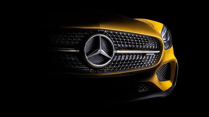 Mercedes-AMG GT Front Grille Close-Up in Gold on Black Background HD wallpaper