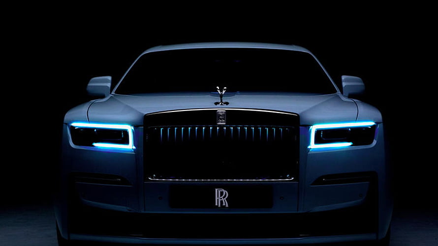 Rolls Royce Front Facade With Glowing Blue LED Headlights In Dark Studio Setting HD wallpaper