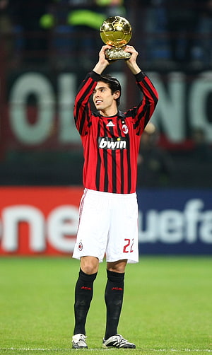 Kaka in AC Milan kit lifting the Golden Ball trophy on the pitch HD phone wallpaper